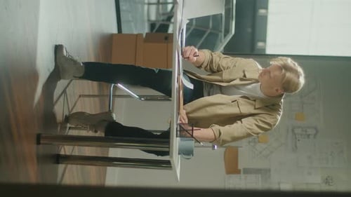 Vertical VideoCreative Man Doing Project Sitting at High Chair Sketching a Plan