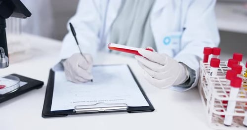 Scientist Analyzing Blood Samples in Laboratory