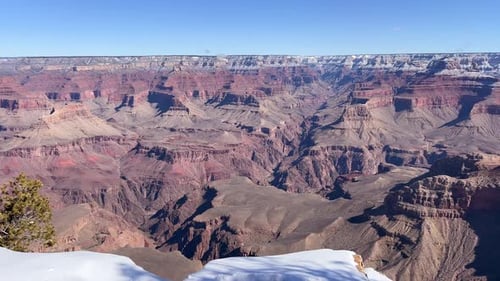 The Breathtaking Landscape of the Grand Canyon Showcases Its Vast Beauty Along with Snowcovered