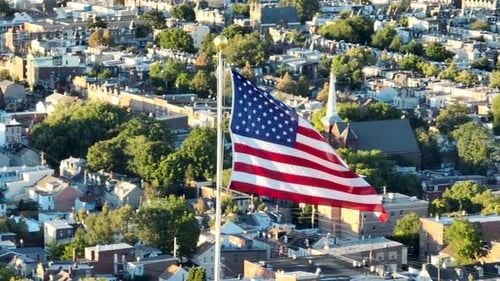 American Flag Waving Over Cityscape