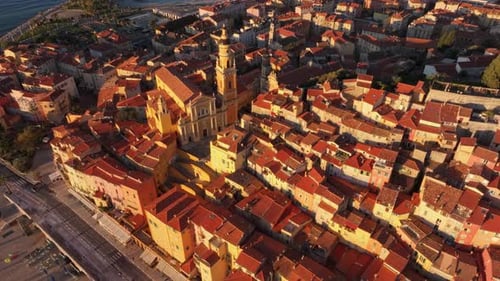 Aerial of Menton coastal charm with golden light on rooftops, France