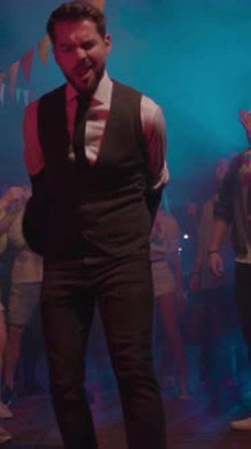 Enthusiastic Man Dancing at a Nighttime Event