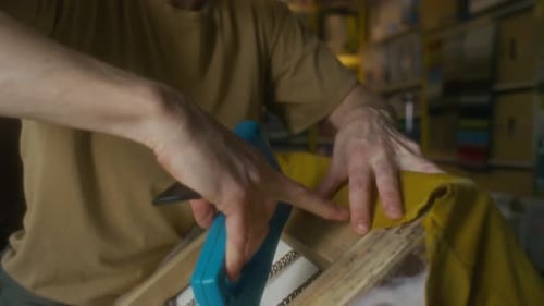Man Repairing Furniture With Staple Gun