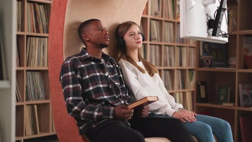 Couple Watches Informative Video in Library