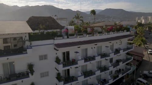 Intriguing drone footage starts at the entrance of an apartment, lifting to reveal the full building