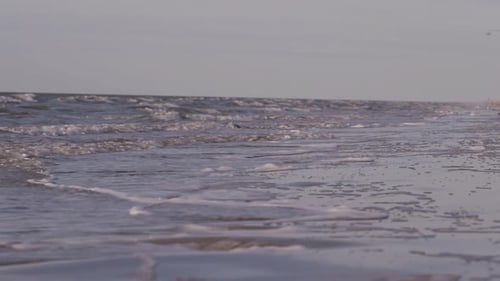 Sea waves rushing at the beach during sunset. Slow Motion Ocean White water Wave surf crashing.
