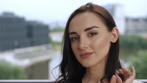 Woman Smiling at Camera in Urban Setting