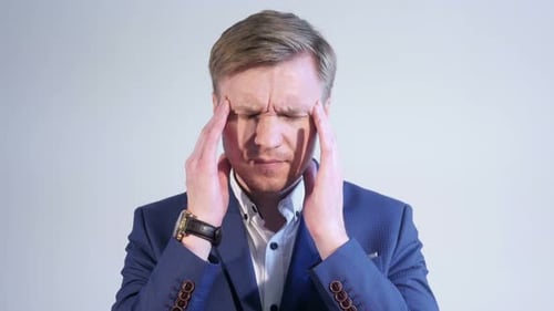 Man in Suit Experiences Headache