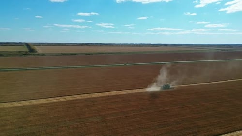 Different Agriculture Machines Harvesting Grain in Wheat Field Drone Point of View.