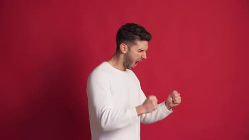 Cheerful Young Man Celebrating and Screaming