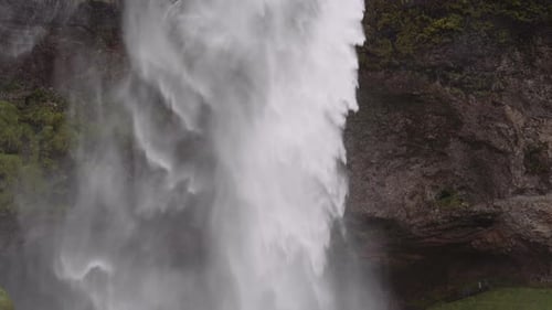 Powerful Waterfall Cascading Down Rocky Cliff