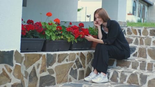 Alone Beautiful Young Woman Enjoying Beautiful Flowers in Her Garden Near Her House