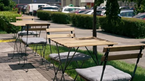 In a Restaurant on the Street Near the Establishment There are Simple Tables for Visitors Seating