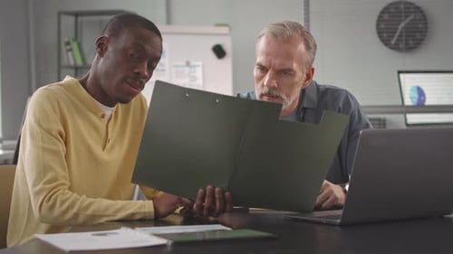 Diverse Colleagues Working with Documents in Office