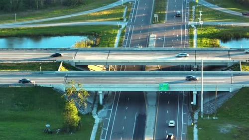 Aerial View of Freeway Overpass Junction with Fast Moving Traffic Cars and Trucks in American Rural