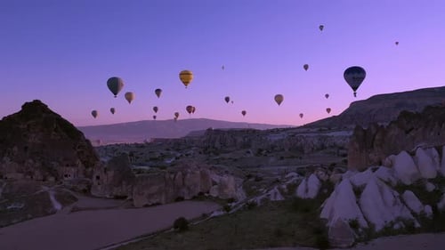 Hot Air Balloons Floating Over Cappadocia Landscape at Sunrise