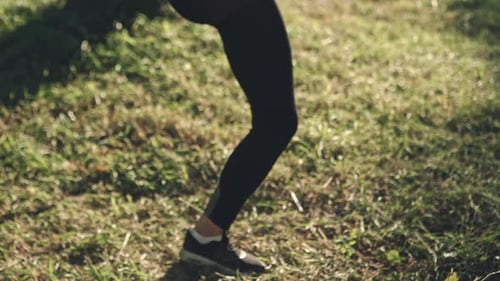 Woman Exercising in the Park in Workout Outfit