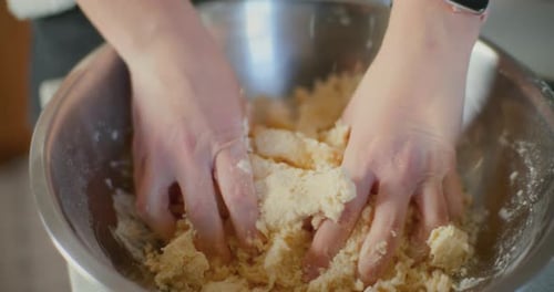 Close Up of Kneading Bread Dough in Metal Bowl