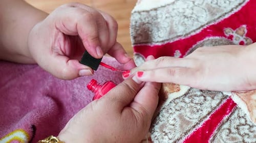 Cosmetologist beautician is making manicure in cosmetology clinic using nippers