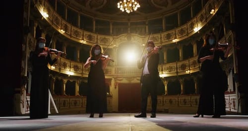 String Quartet Playing Violins in Historic Theater