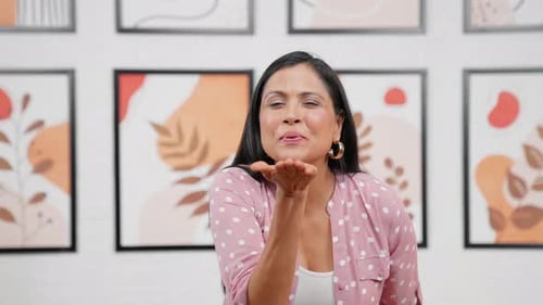 Smiling Woman Blowing a Kiss to Camera