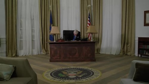 Man at Desk Reading and Writing in Office