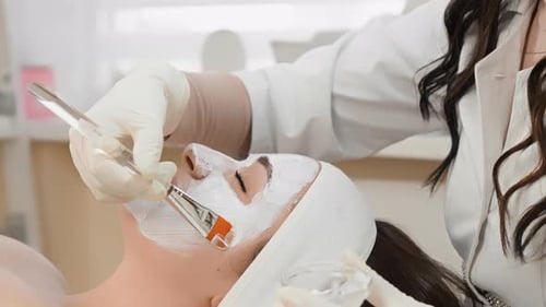 Woman Receiving a Facial Treatment at a Spa