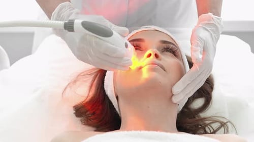 Woman Receiving Modern Facial Skin Treatment