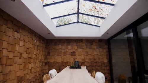 Modern Dining Room with Natural Light and Wood Paneling