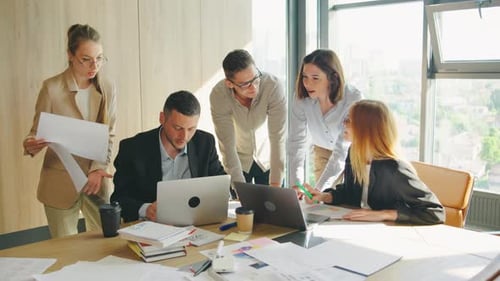 In a Modern Office Dedicated Business Professionals Work on a Project Emphasizing Collaboration and