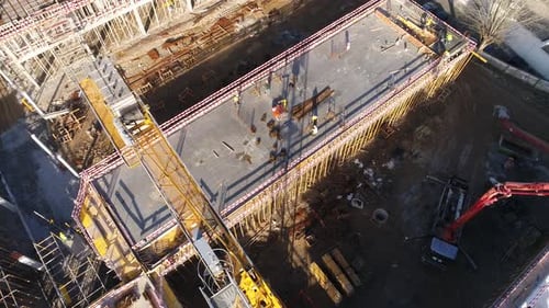 Construction Workers on Top of a Concrete Structure