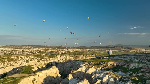 Hot Air Balloons Fly Over the Mountainous Landscape of Cappadocia Turkey
