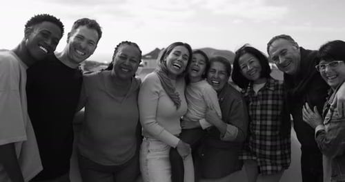 Diverse group of people laughing and hugging together