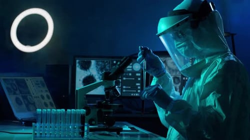 Scientist analyzing sample with microscope in lab