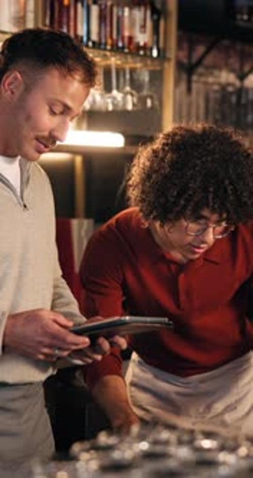 Bartender, manager and teamwork at pub with tablet, inventory checklist