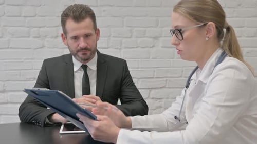 Female Doctor Discussing Medical Report with Patient
