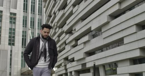 Concept of handsome middle age man thoughtfully walks in downtown business district stare into the g