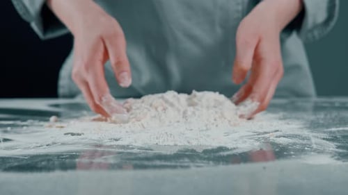 Person Mixing Flour By Hand in Kitchen