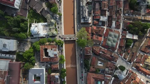 Drone view of the river open to traffic passing through the middle of the Bosnian city, aerial drone