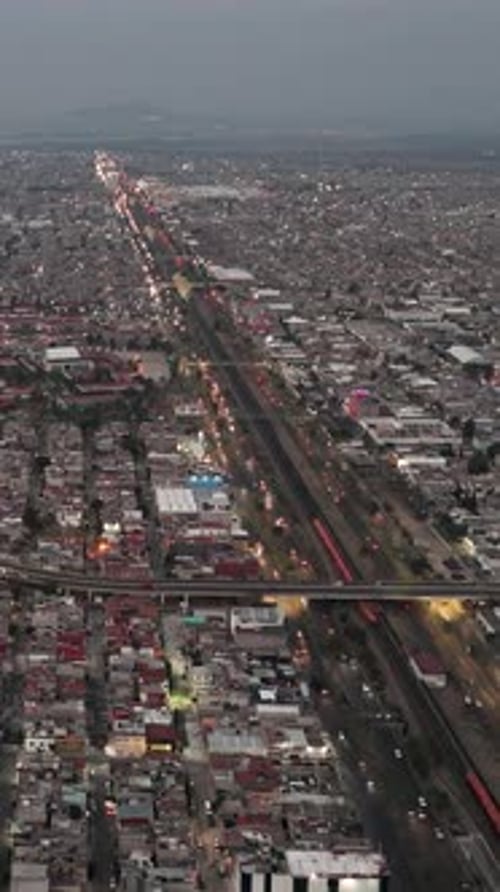 Dusk falls, Ecatepec glows with illumination in a vertical perspective