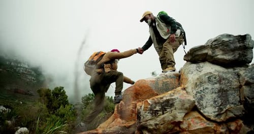 Men Helping Each Other on Rocky Mountain Climb