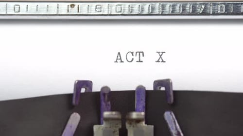 Act Ten word closeup being typing and centered on a sheet of paper on old vintage typewriter