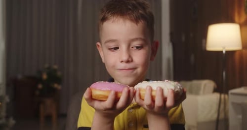 Caucasian Child with an Eating Disorder Quickly Wants to Eat Two Donuts at Same Time and Cannot