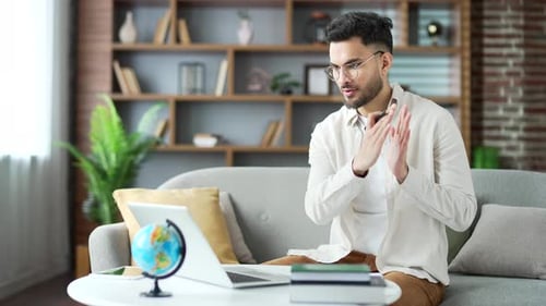 Man Video Calling and Explaining Online at Home
