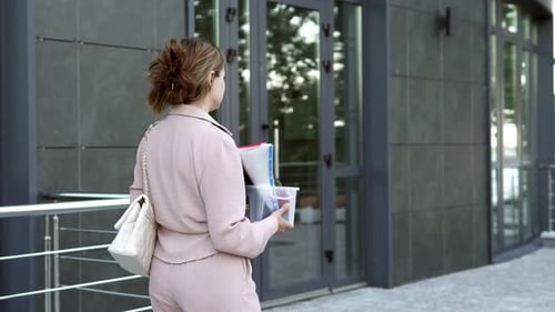 Woman Leaving Office with Box of Supplies