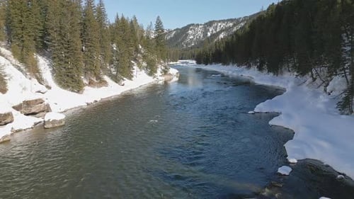 Flying over the Snake River during winter as it winds through the landscape