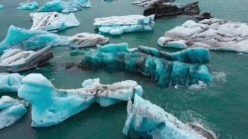 Pieces of iceberg floating in the ocean. Drone video.