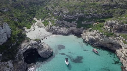 Top Down Drone View Over a Bay with Crystal Clear Water and White Boats