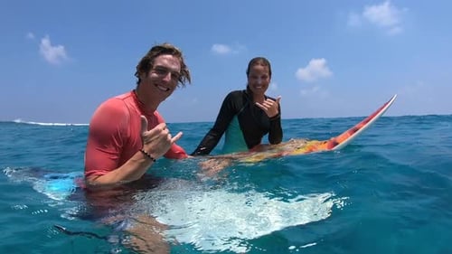 Surfers Smiling in the Turquoise Ocean Water
