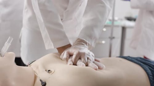 Doctors Practicing CPR on Medical Training Mannequin